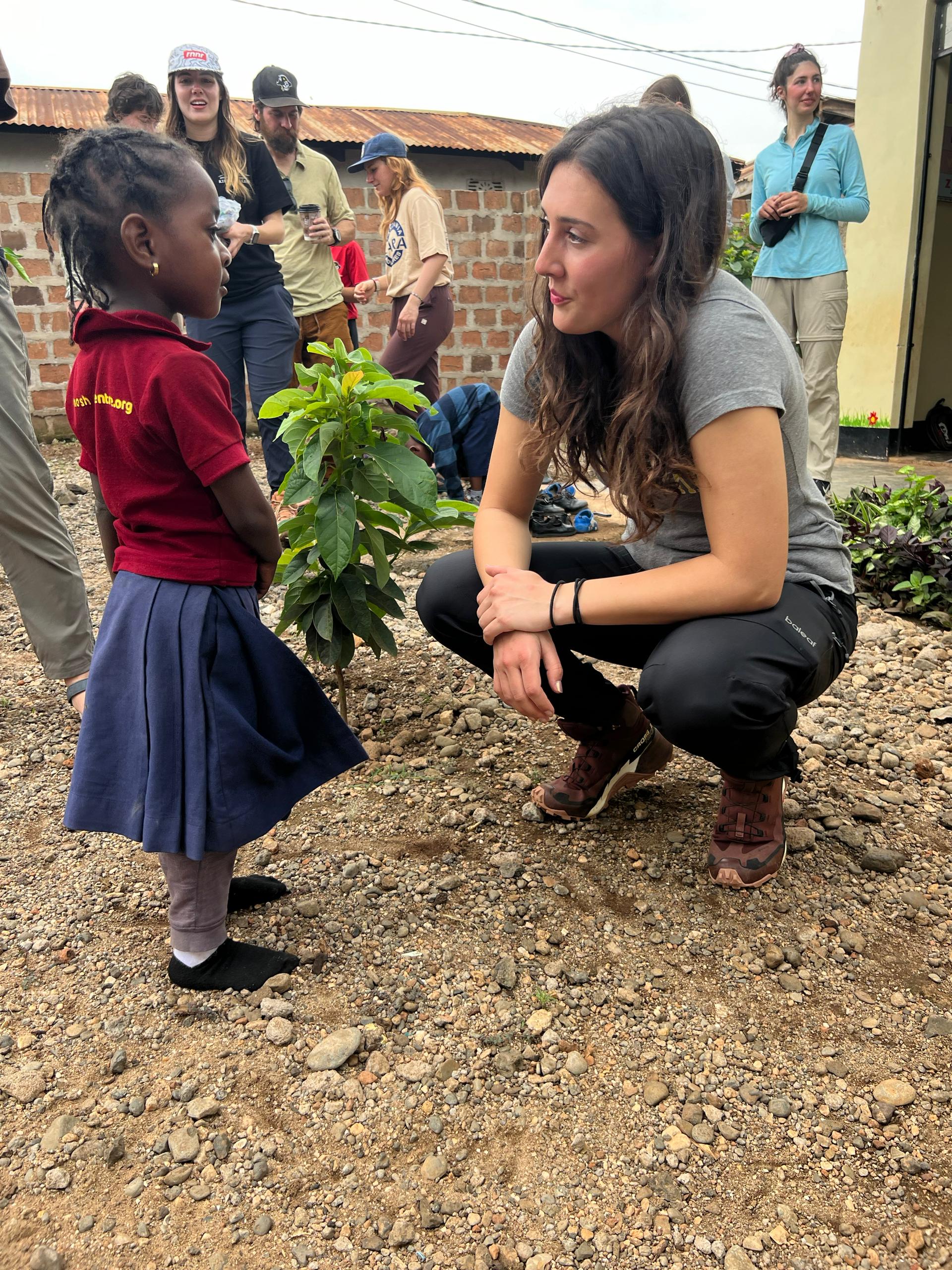 Volunteer with a child in Tanzania, fostering education and mentorship through hands-on community engagement and support